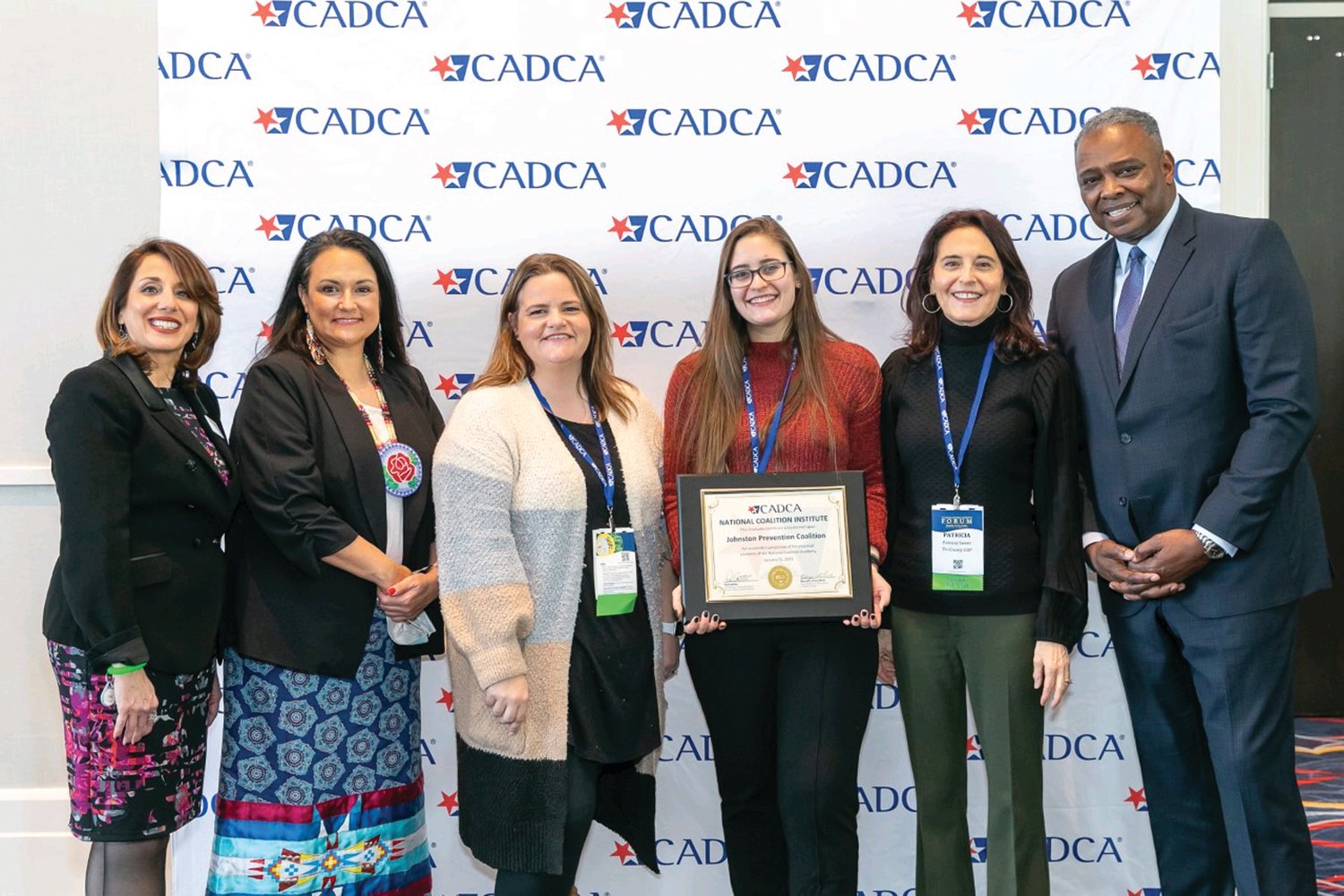 NATIONAL AWARD: From left to right, Pat Castillo – National Coalition Institute Director, Jeannie Hovland – CADCA Board Member, Andrea Paiva, Kaitlyn Maggiore, Patricia Sweet – Johnston Prevention Coalition and General Barrye Price – CADCA President & CEO.